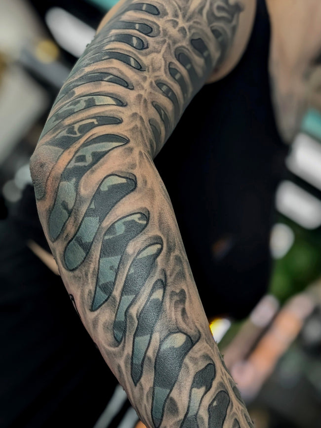 bioorganic industrial sleeve tattoo – full arm abstraction, heavy color forms