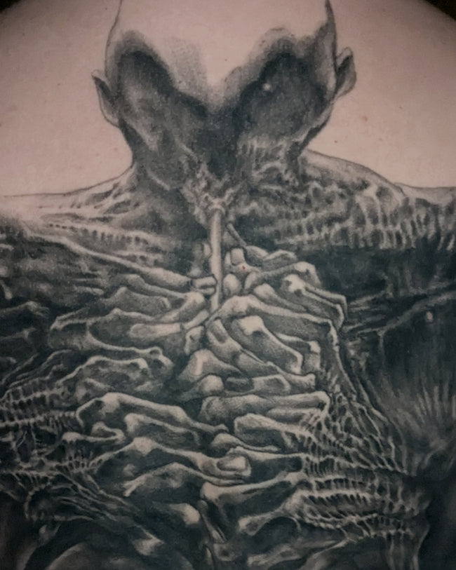 realistic black and grey tattoo – musician figure inspired by Zdzislaw Beksinski painting, full back piece