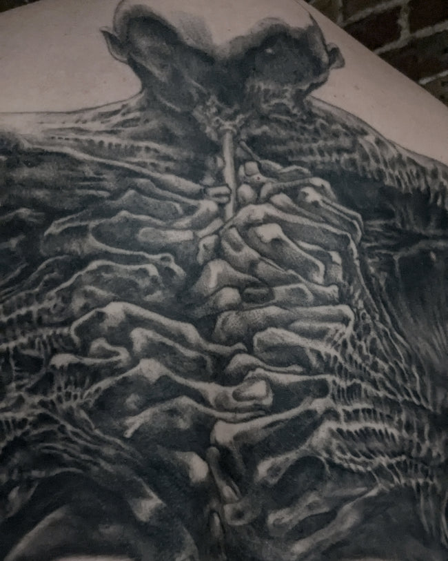 realistic Beksinski tattoo detail – black and grey musician closeup from full back composition