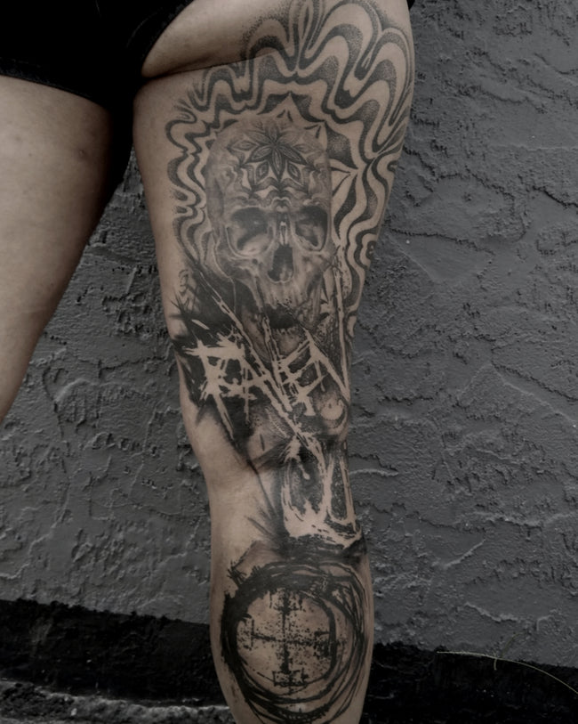 black and grey leg sleeve – realistic skull with dotwork mandala pattern, Nordic symbols and street art text, heavy black ink strokes