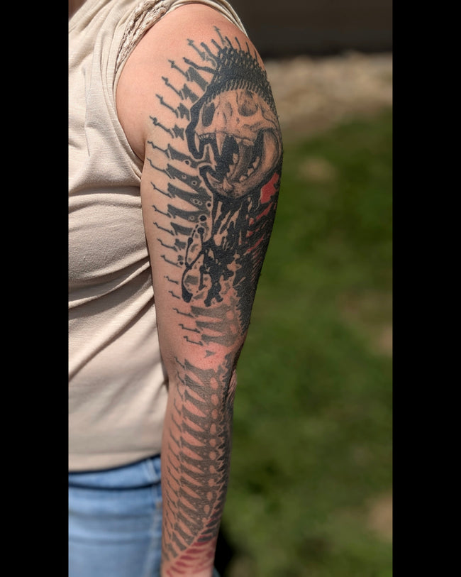 bioorganic industrial sleeve tattoo – black, gray and red pattern with realistic cat skull center