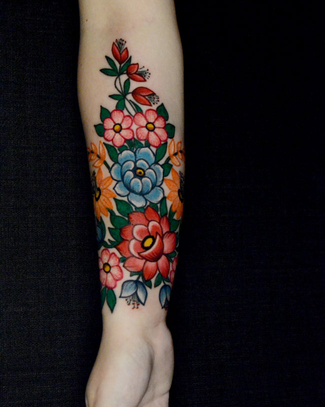 traditional Polish floral tattoo – Zalipie village inspired full color on forearm