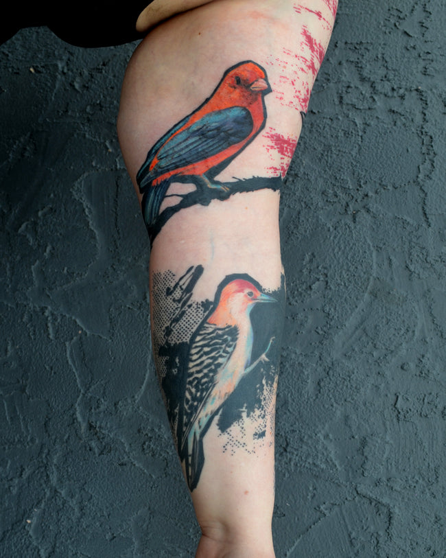 realistic color bird sleeve tattoo – heavy black and red brushstroke with Slavic pattern, detail closeup