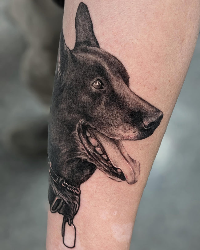 ealistic dog portrait tattoo – black and grey forearm piece