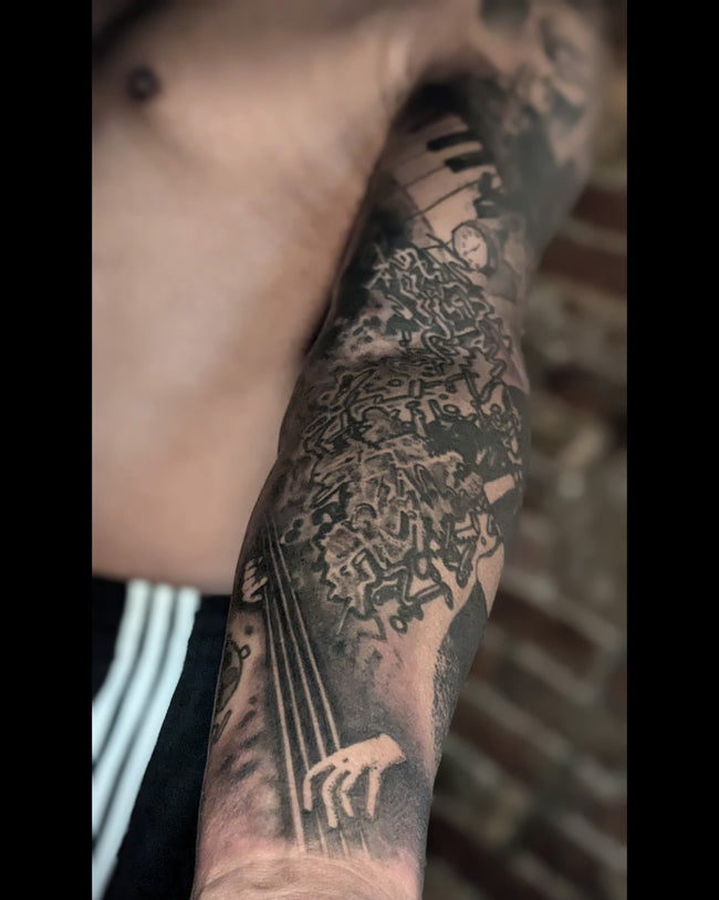 realistic portrait sleeve tattoo detail – black and grey musical graphic inspired by Waldemar Swierzy