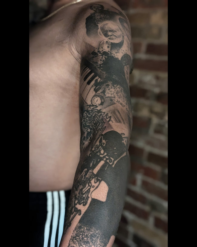 realistic portrait sleeve tattoo detail – black and grey composition inspired by Waldemar Swierzy art