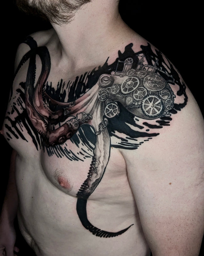 steampunk octopus tattoo detail – black and grey with industrial pattern background, chest closeup